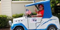 THE VILLAGES, FL - OCTOBER 23: A supporter of Donald Trump drives by the Joe Biden rally in the golf cart during President Donald Trump's campaign stop at The Villages Polo Club on October 23, 2020 in The Villages, Florida. Supporters gather to help increase voter turn out in a heavily Republican voter district. (Photo by Octavio Jones/Getty Images)