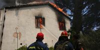 epa09401101 Firemen battle a wildfire burning a house in Kryoneri area, near Athens, Greece, 06 August 2021. The fires in Attica continued to blaze uncontrollably on Friday, along all three fronts that formed during the night, at the side of the Athens-Lamia national highway toward Kapandriti, on the foothills of Parnitha in Afidnes and in Ippokratios Politia where both homes and businesses were burned. Another major problem caused by the fires is the thick smoke that has blanketed the Attica sky, creating a stifling atmosphere. Among the forces fighting the flames are 83 fire-fighters sent from France, who arrived in Greece on 06 August. The situation, already extremely difficult, is expected to get worse during the day as wind intensity picks up and starts to fan the flames.  EPA-EFE/ORESTIS PANAGIOTOU