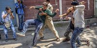 An Indian policeman tries to detain a Kashmiri Shiite at a religious ceremony during curfew-like restrictions in the city centre on 8 September 2019 in Srinagar, the summer capital of Indian-administered Kashmir, India. (Photo: Yawar Nazir / Getty Images)
