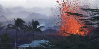 KAPOHO, HI - MAY 18:  Lava erupts  from a Kilauea volcano fissure near a home at dawn on Hawaii's Big Island on May 18, 2018 in Kapoho, Hawaii. The U.S. Geological Survey said the volcano erupted explosively on May 17 launching a plume about 30,000 feet into the sky.  (Photo by Mario Tama/Getty Images)