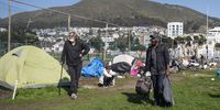 Law enforcement officers removes tents around Sea Point Tennis Courts on 23 August 2021 in Cape Town, South Africa. Displaced  people found refuge at the tennis courts because of the increased homeless after the COVID-19 lockdown. (Photo by Gallo Images/Brenton Geach)