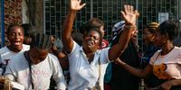 Women (zungueiras) cry and sing at the news of the death of the former Angolan president José Eduardo dos Santos, in the neighbourhood of Sao Paulo, Luanda, Angola, on 8 July 2022. (Photo: EPA-EFE / Ampe Rogerio)