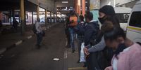 Passengers stand in line as they wait for a taxi. Small queues are an unusual sight at one of the busiest taxi ranks in Joburg during peak hours. (Photo: Shiraaz Mohamed)