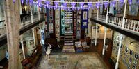 An aerial view of the interior of the District Six Museum shows a large street map of the historic area overlaid with a protective plastic cover on the floor. Towards the back stands a tower of street names also taken from the area before everything was torn down. Cape Town on 24 April, 2023. (Photo: Shelley Christians)