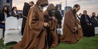 ERBIL, IRAQ - MARCH 07: Monks pray during a mass conducted by Pope Francis at the  Franso Hariri Stadium on March 07, 2021 in Erbil, Iraq. Pope Francis arrived in Erbil, the final stop of his historic four-day visit, the first ever papal visit to Iraq. In his first foreign trip since the start of the pandemic Pope Francis visited Baghdad, Najaf, Erbil and the cities of Qaraqosh and Mosul, which were heavily destroyed by ISIS. Although the trip is seen as an act of solidarity, the Vatican has been forced to defend the decision to go ahead with the papal visit amid the ongoing coronavirus pandemic, as Iraq is currently seeing a spike in infection rates as it faces a deadly second wave of the virus. (Photo by Chris McGrath/Getty Images)