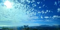 Sunday sun filtered through clouds as seen over Somerset West from Sir Lowry's Pass. Image: Lara Bartie