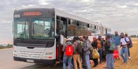 Commuters in a rural area outside White River, Mpumalanga, catch an afternoon bus home. As a legacy of apartheid spatial planning, many commuters have to take multiple buses and travel about two hours each way from home to work.   <br>(Photo: Maru Attwood)
