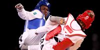 CHIBA, JAPAN - JULY 26: Ruth Gbagbi (L) of Team Ivory Coast competes against Milena Titoneli of Team Brazil Women's -67kg Taekwondo Bronze Medal contest on day three of the Tokyo 2020 Olympic Games at Makuhari Messe Hall on July 26, 2021 in Chiba, Japan. (Photo by Maja Hitij/Getty Images)