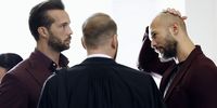 Former professional kickboxer and social media influencer Andrew Tate (R) and his brother Tristan (L) chat with one of their lawyers, Eugen Vidineac (C), before a preliminary appeal hearing held at the Bucharest Appeal Court in Bucharest, Romania, 15 October 2024. Andrew Tate and his brother Tristan were arrested on 29 December 2022 as a result of the DIICOT (Directorate for Investigating Organized Crime and Terrorism) inquiry on charges of human trafficking and intention to form an organized crime group. Romanian police stated that the two brothers and their associates coerced victims for creating a paid pornography service for social media platforms. The trial itself has not yet started, although the investigation in the Tate case has been going on for almost two years.  EPA-EFE/ROBERT GHEMENT