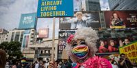 TOKYO, JAPAN - JUNE 06: A participant poses for a photograph during a rally calling for the anti-discrimination legislation in front of Shibuya station on June 06, 2021 in Tokyo, Japan. Among the G7 nations, Japan remains the only member to not legally recognize same-sex couples, even as many Japanese municipalities and prefectures provide same-sex partnership certificates. (Photo by Takashi Aoyama/Getty Images)
