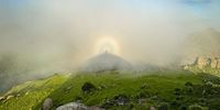 A fogbow highlights the nipple shadow of Sheba’s Breast summit. Photographer: Darron Raw
