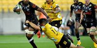 The Sharks' Sikhumbuzo Notshe, left, is tackled by the Hurricanes' Jackson Garden-Bachop during their Super Rugby match in Wellington, New Zealand on 15 February 2020. (Photo: Marty Melville)