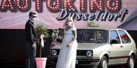 DUSSELDORF, GERMANY - MAY 05:  Bride Janine Scholz, wearing a protective face mask and dressed in a cream white dress runs arrives the car park prior to her marrigare to Philip Scholz during the first ever wedding ceremony at the Autokino Dusseldorf drive-in cinema during the novel coronavirus crisis on May 5, 2020 in Dusseldorf, Germany. A total of three couples are marrying at the drive-in today with guests allowed to attend in their cars. Drive-in cinemas have become a popular alternative venue for events ranging from weddings, theatre performances, musicals and movies as lockdown measures keep traditional venues off limits. (Photo by Andreas Rentz/Getty Images)