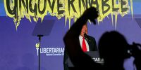 A person in the crowd gestures as former U.S. President and Republican presidential candidate Donald Trump speaks at the Libertarian Party's national convention in Washington, U.S., May 25, 2024. REUTERS/Brian Snyder     TPX IMAGES OF THE DAY