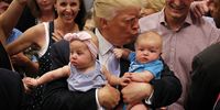 COLORADO SPRINGS, CO - JULY 29: Republican presidential nominee Donald Trump kisses three-month-old Kellen Campbell, of Denver, right, and holds six-month-old Evelyn Keane, of Castel Rock, Colo., after Trump's speech at the Gallogly Event Center on the campus of the University of Colorado on July 29, 2016 in Colorado Springs, Colorado. (Photo by Joe Mahoney/Getty Images)
