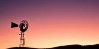 Wind pumps make for fascinating silhouettes. This old faithful is silhouetted against the inner ring of the Vredefort Dome collar rocks. Image: Johan Smit