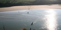 Hikers cross a section of the Mtentu River to reach the northern section of Mkambati Nature Reserve.