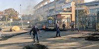 Police clean up rubble at the entrance to the Bheki Mlangeni District Hospital.<br>(Photo: Bheki Simelane)