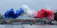 Smoke clouds in the tricolours of the France flag are seen at Pont d'Austerlitz during the Opening Ceremony of the Olympic Games Paris 2024 on July 26, 2024 in Paris, France. (Photo by Ann Wang - Pool/Getty Images)
