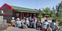 Patients waiting outside Alheit Primary Health Care Clinic outside Kakamas in the Northern Cape.(Photo: Thom Pierce / Spotlight)