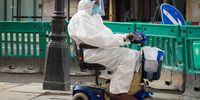 LONDON, UNITED KINGDOM - JULY 02: A person wearing a full protective suit and face mask travels along Regent Street in a mobility scooter on July 02, 2020 in London, United Kingdom. Many UK businesses are announcing job losses due to the effects of the Coronavirus Pandemic and Lockdown. (Photo by Leon Neal/Getty Images)