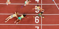 TOKYO, JAPAN - JULY 31: Runners pass their batons in the 4x400m Relay Mixed Final on day eight of the Tokyo 2020 Olympic Games at Olympic Stadium on July 31, 2021 in Tokyo, Japan. (Photo by Richard Heathcote/Getty Images)