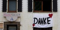 epa09421239 A banner with the inscription 'Thank You' (Danke) hangs on a damaged winegrower's restaurant five weeks after the flooding of the Ahr River, in Dernau in the district of Ahrweiler, Germany, 19 August 2021. Large parts of Western Germany were hit by heavy, continuous rain in the night to 15 July resulting in local flash floods that destroyed buildings and swept away cars.  EPA-EFE/FRIEDEMANN VOGEL