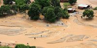 People cross a flooded area in Muloza on the border with Mozambique in the aftermath of Cyclone Freddy, about 100km outside Blantyre, Malawi, March 18, 2023. (Photo: Reuters / Esa Alexander)