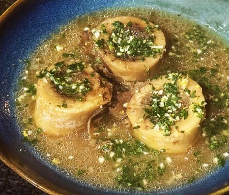 Roasted marrow bones in a beef and onion broth, with gremolata
