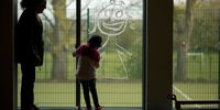 A young girl paints a picture of herself on the school window as children of key workers take part in school activities at Oldfield Brow Primary School on April 08, 2020 in Altrincham, England. The government announced the closure of UK schools from March 20 except for the children of key workers, such as NHS staff, and vulnerable pupils, such as those looked after by local authorities. The prime minister has said schools will remain closed "until further notice," and many speculate they may not reopen until next term. (Photo by Christopher Furlong/Getty Images)