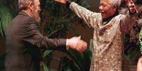 South African President Nelson Mandela greets Cuban leader Fidel Castro as he arrives for the opening of the 12th Non-Aligned Movement summit in Durban on 2 September 1998. (Photo: ODD Andersen / AFP)