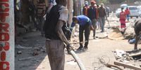 Some Alexandra residents collect what is left of migrant owned stores near Pan Africa Supermarket in Alexandra, Gauteng on 5 September. This follows after looters and arsonist targeted migrant-rich businesses in parts of Gauteng from the 3 September- 5 September 2019. Photo: Chanel Retief