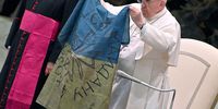 Pope Francis shows a flag of Ukraine that was sent to him from the Ukrainian town of Bucha during the weekly general audience in the Paul VI Audience Hall, in Vatican City, 06 April 2022 ?(reissued 21 April 2025). Pope Francis died on 21 April 2025 at the age of 88, according to the Holy See. Born Jorge Mario Bergoglio in Buenos Aires, Argentina on 17 December 1936, was appointed leader of the Catholic Church on 13 March 2013 succeeding pontiff Emeritus Benedict XVI. ( EPA-EFE / ETTORE FERRARI )