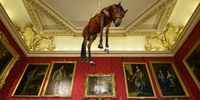 "Novecento", a taxidermy horse suspended from the ceiling, created by artist Maurizio Cattelan, is seen at Blenheim Palace on September 12, 2019 in Woodstock, England.  The Italian artist is known as the prankster of the art world.  His most notable piece being "America" a solid gold usable toilet which had art lovers queuing to use when it was shown at the Guggenheim Museum in New York. (Photo by Leon Neal/Getty Images)