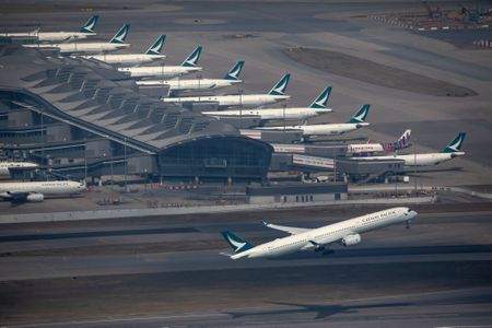 Cargo plane slides off runway in Hong Kong, media reports two dead