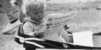 July 1962:  Young Roy Turner at Henley regatta prefers to read the paper in his pram.  (Photo by Evening Standard/Getty Images)