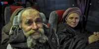 epa09827538 Refugees from Mariupol sit in a bus crossing the Ukraine-Russia border at the border crossing point Veselo-Voznesenka in the Rostov region, Russia, 15 March 2022. Civilians were able to leave the city, on 15 March, thanks to humanitarian corridors organised by the Russian military, with housing and food have been prepared in Russia for those who fled from Mariupol. On 24 February Russian troops had entered Ukrainian territory in what the Russian president declared a 'special military operation', resulting in fighting and destruction in the country, a huge flow of refugees, and multiple sanctions against Russia.  EPA-EFE/ARKADY BUDNITSKY