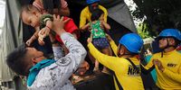 Filipino military personnel help evacuees to disembark from a truck during a mass evacuation at a school turned into an evacuation center in Santo Domingo, Albay, Philippines, 13 June 2013. Lava started to flow toward villages and ash rained houses in the Mayon volcano danger zone, according to fleeing villagers.  EPA-EFE/FRANCIS R. MALASIG