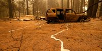 INDIAN FALLS, CALIFORNIA - JULY 26: A burned out car sits near a home that was destroyed by the Dixie Fire on July 26, 2021 in Indian Falls, California. The Dixie Fire, currently the largest wildfire in California, has burned nearly 200,000 acres and destroyed at least 20 structures. The fire is 22 percent contained. (Photo by Justin Sullivan/Getty Images)