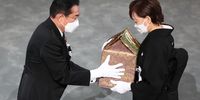 TOKYO, JAPAN - SEPTEMBER 27: Japan's Prime Minister Fumio Kishida hands off the urn containing Shinzo Abe's ashes to the widow of former Japanese prime minister Shinzo Abe, Akie Abe during the state funeral for Japan's former prime minister Shinzo Abe on September 27, 2022 at the Budokan in Tokyo, Japan. Several current and former heads of state visited Japan for the state funeral of Abe, who was assassinated in July while campaigning on a street. (Photo by Takashi Aoyama/Getty Images)