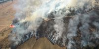 Smoke rises above farm and environmentally protected land while on fire near Sao Jose do Rio Pardo, Sao Paulo state, Brazil, on Tuesday, Aug. 24, 2021. Extreme weather is slamming crops across the globe, bringing with it the threat of further food inflation at a time costs are already hovering near the highest in a decade and hunger is on the rise. Photographer: Jonne Roriz/Bloomberg via Getty Images