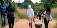 Locals share the road with Joseph ‘Travel Mufasa’ Makowa who walked across Zimbabwe. (Screengrab: Wild Africa Fund)
