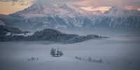 "Foggy winter sunrise at St. Thomas Church". A  winter morning at St. Thomas Church, in Slovenia. I had already photographed the area the summer before, and decided to return here in the winter. I wanted to capture the white-clad landscape with the mountains lit by the first rays of sun in the background. © Peter Leyer, Hungary, Shortlist, Open, Landscape, 2022 Sony World Photography Awards