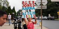 A lone protester stands outside the Waterbury Superior Court during the start of the case involving Alex Jones, who called the 2012 Sandy Hook shooting a hoax. (Photo: Spencer Platt / Getty Images)