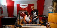 Bush Radio producers (from left) Lydia Marwanqana and Mkuseli  ‘Khusi’ Veto go live in the  ’production studio‘ at Bush Radio‘s offices in Salt River (Photo: Shelley Christians)