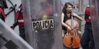 Police dressed in riot gear walk past a woman playing a cello during International Safe Abortion Day in Mexico City, Mexico, on Wednesday, Sept. 28, 2022. International Safe Abortion Day was launched in 1990 in Latin America in support of the right to safe abortion and in 2011 was recognized globally. Photographer: Toya Sarno Jordan/Bloomberg via Getty Images