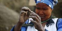 A woman holds what she believes to be a diamond after the discovery of unidentified stones at KwaHlathi village near Ladysmith on 17 June 2021 in KwaZulu-Natal, South Africa. (Photo: Felix Dlangamandla)