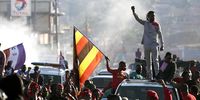 Robert Kyagulanyi Ssentamu salutes the crowd as he passes through Mukono on the outskirts of Kampala during his presidential campaign. (Photo: EPA-EFE / STR)