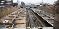 Scavengers on the railway track at the Jeppe train station in Johannesburg as they prepare to cut cables to be sold as scrap metal.<br>(Photo: Shiraaz Mohamed)