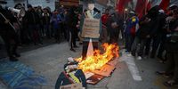 Demonstrators burn an image of Ecuadorian President Daniel Noboa during a protest against his government in Quito, Ecuador, 04 July 2024. Unions in Ecuador protested against Noboa's government's economic measures, which significantly increased the price of the most consumed gasoline by reducing subsidies for these fuels.  EPA-EFE/JOSE JACOME